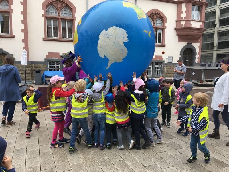 Foto: Kinder heben großen Erdball